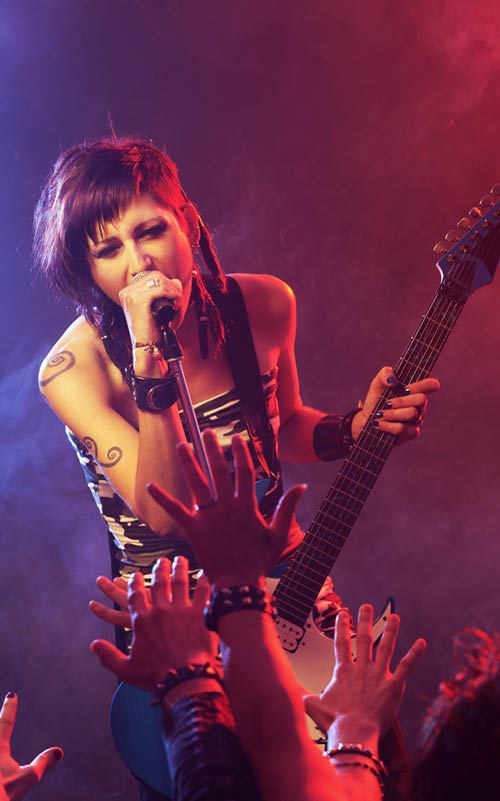 Female singer and guitarist at a rock concert